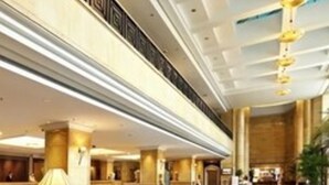 A spacious lobby with a reception desk, seating area, and a large chandelier. - Ningbo Nanyuan Hotel (Ningbo)