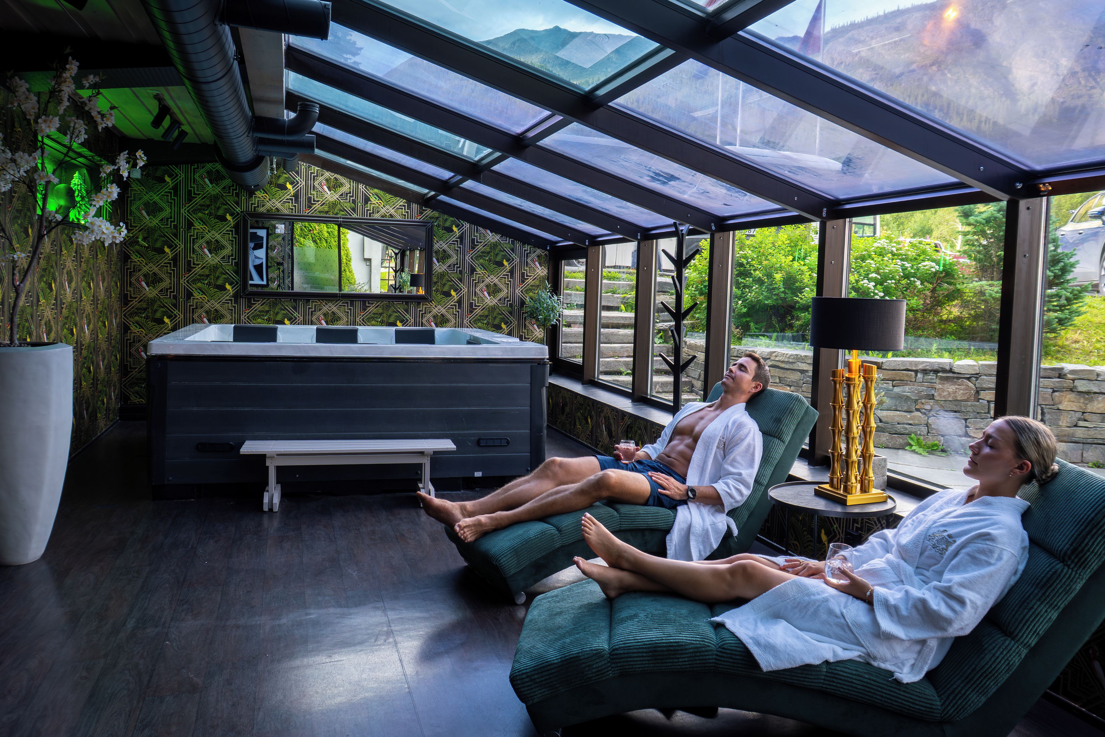 A modern spa area with a glass-enclosed room, a hot tub, and a view of the outdoors.