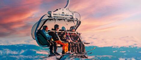 A ski lift with passengers and skis.