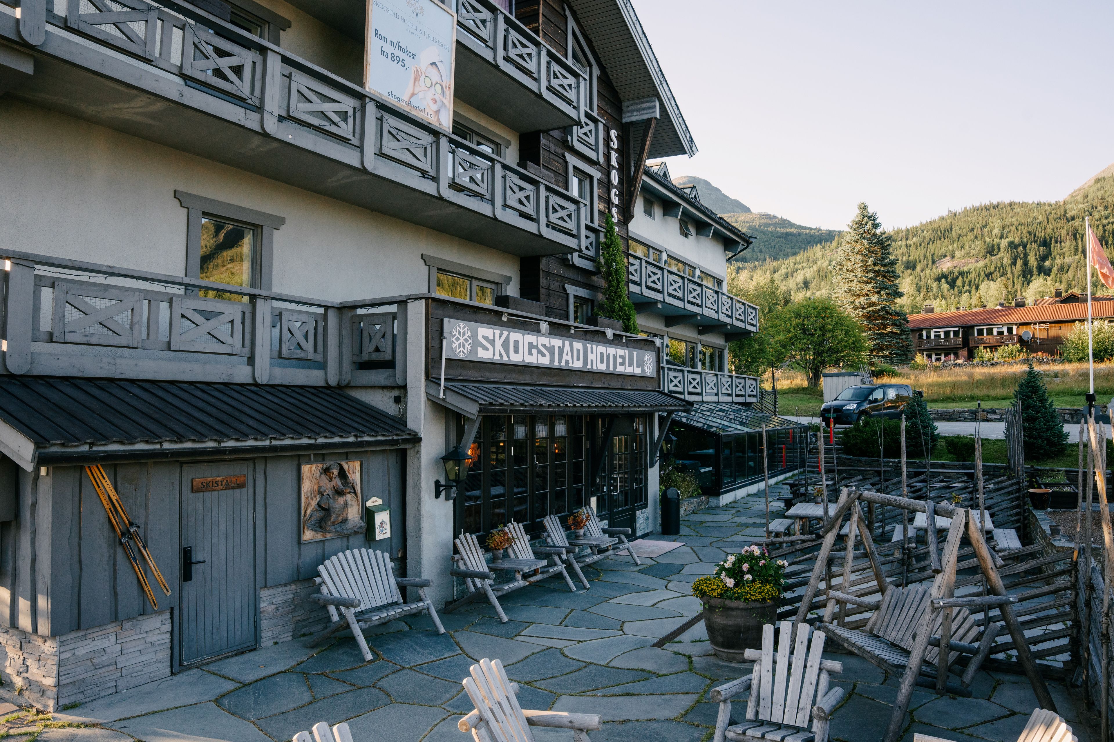 A traditional wooden building with a sign for Skogstad Hotel.