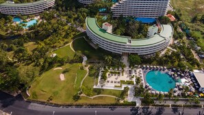 A resort with multiple circular buildings, a central pool, and lush greenery. - Pullman Phuket Karon Beach Resort (Karon)