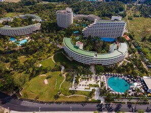 A resort with multiple circular buildings, a central pool, and lush greenery. - Pullman Phuket Karon Beach Resort (Karon)
