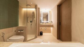 A modern bathroom with a walk-in shower, a toilet, a bathtub, and a vanity with a mirror.