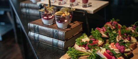 A buffet table with various food items and drinks.