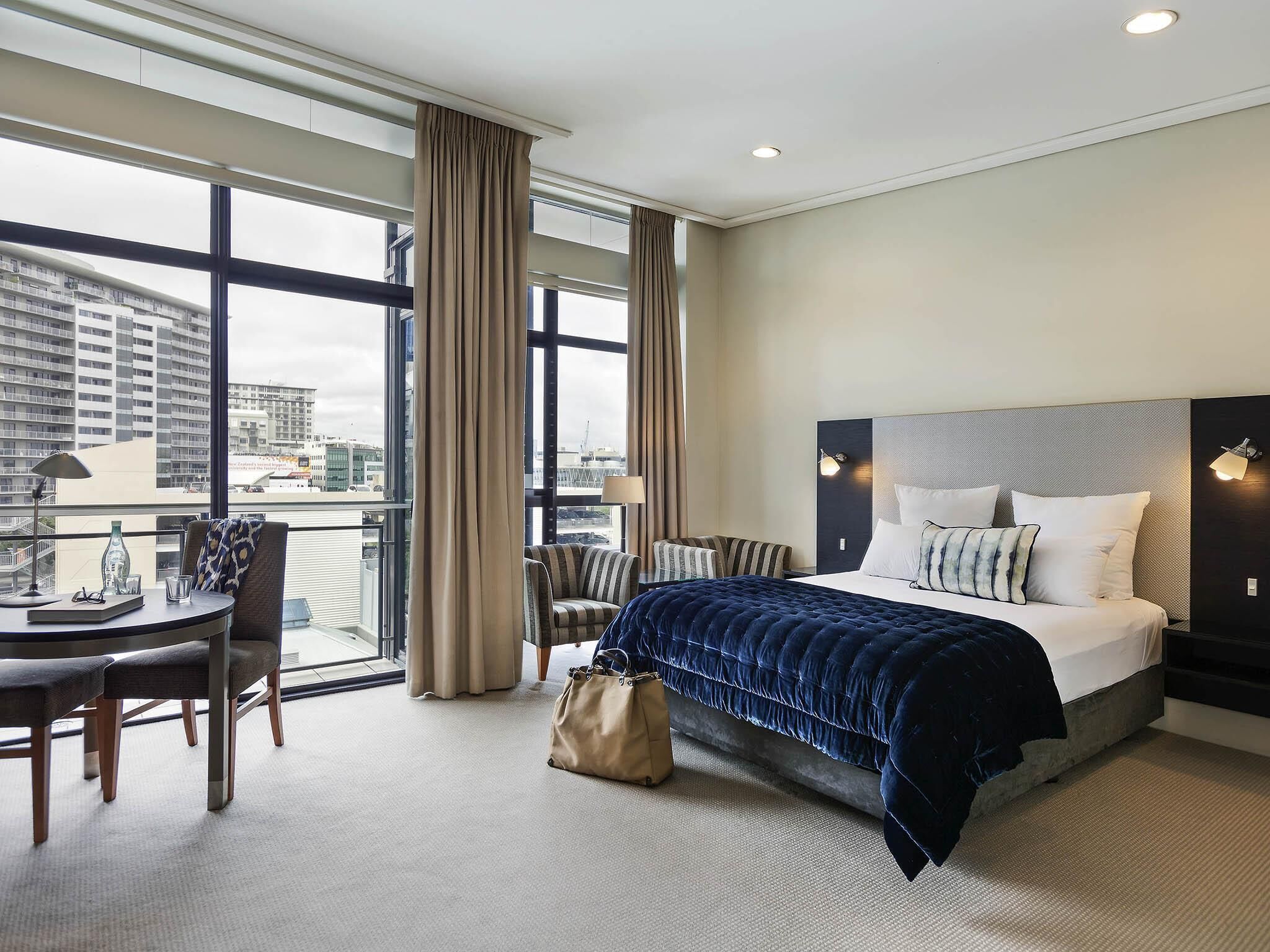 Studio, 1 Queen Bed, City View | Minibar, in-room safe, desk, iron/ironing board