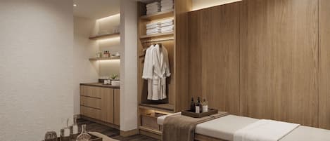 A modern bathroom with a wooden vanity, a towel rack, and a bedside table with toiletries.