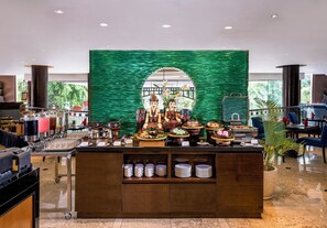A buffet area with a variety of food items and a decorative backdrop. - Hotel Ciputra Semarang (Semarang)
