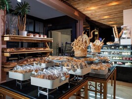 A bakery display with various baked goods and pastries.