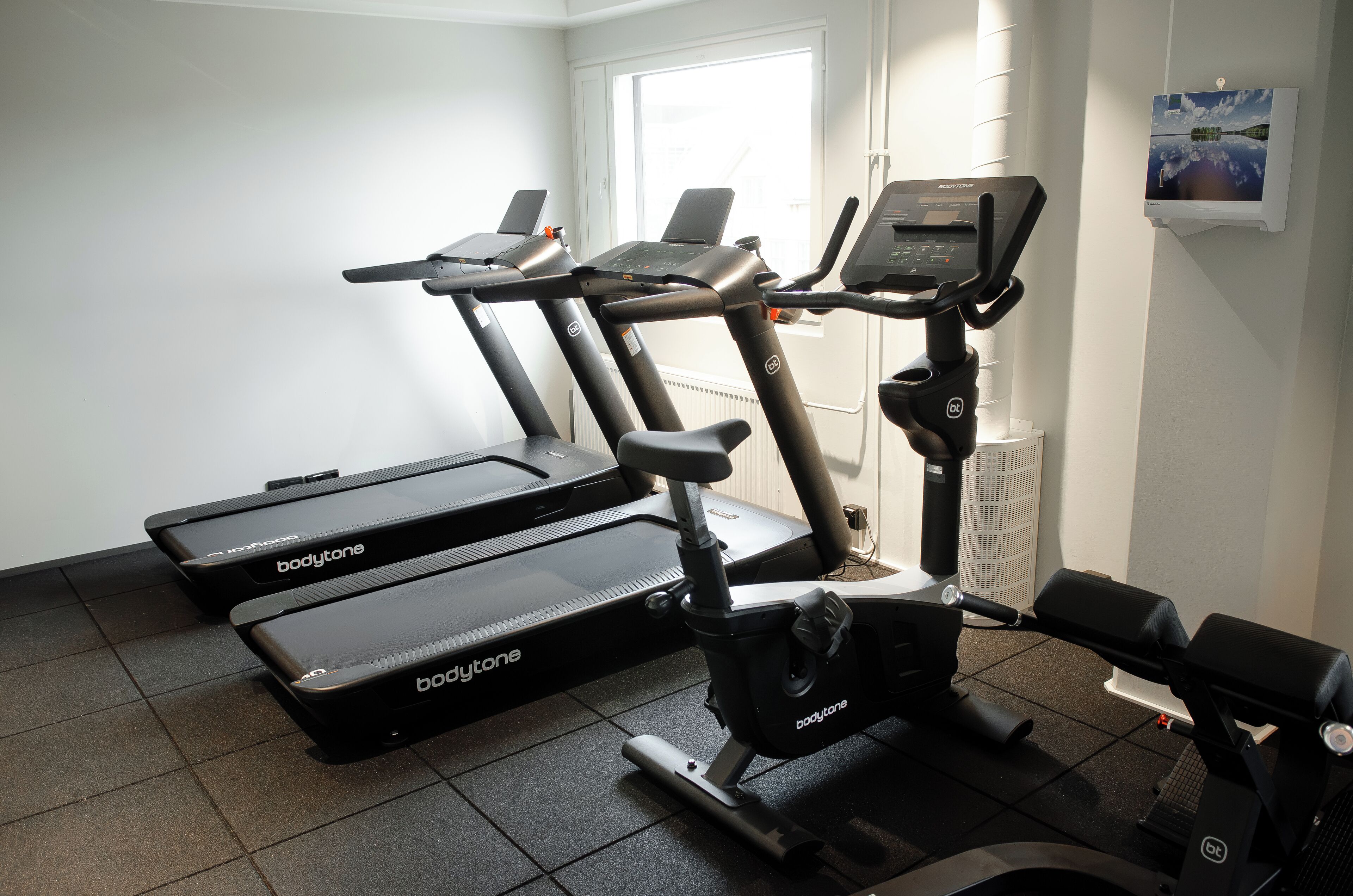 A gym with treadmills and an elliptical machine.