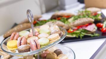 A buffet with macarons and a salad.
