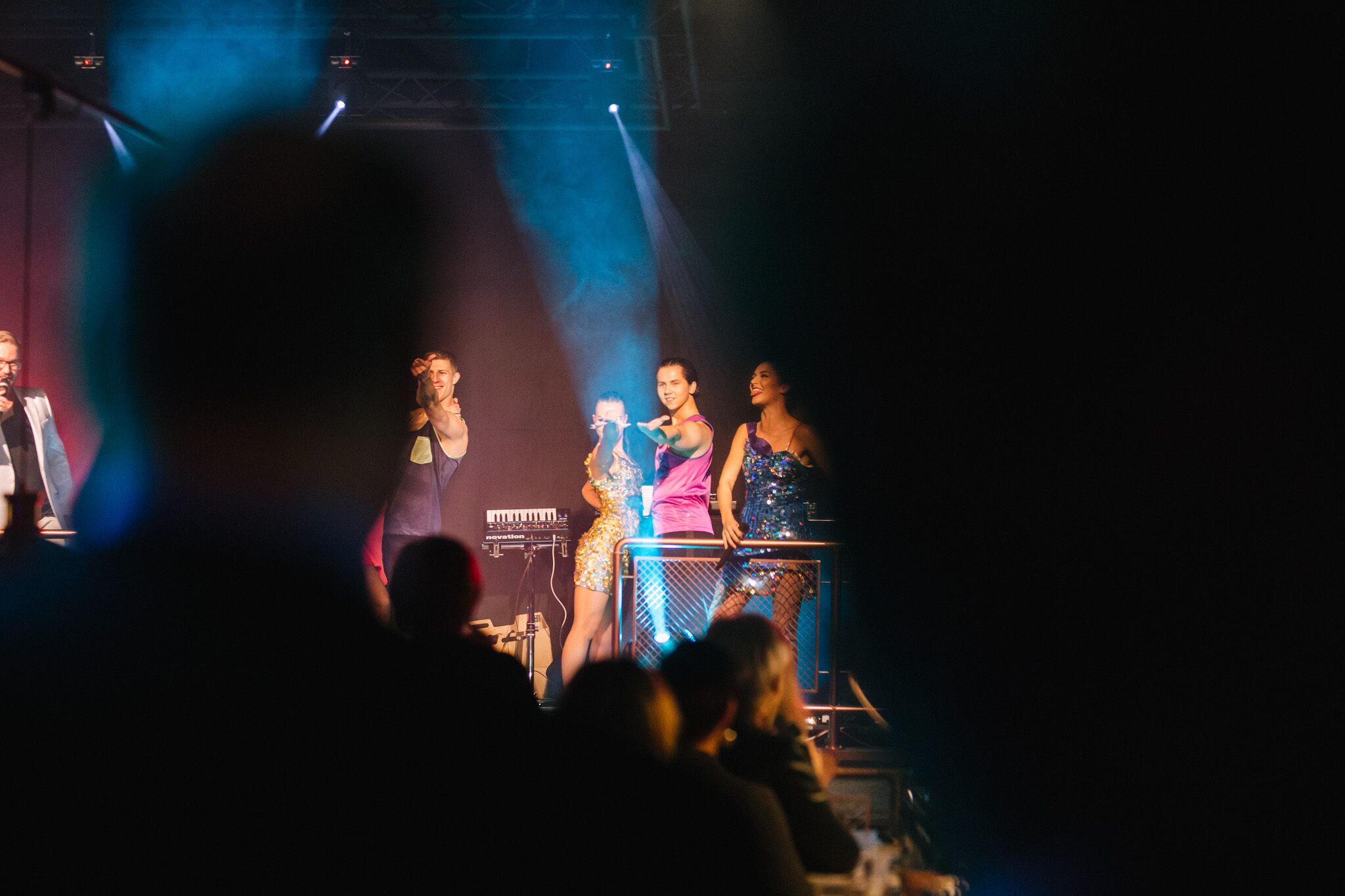 A stage with performers and an audience.