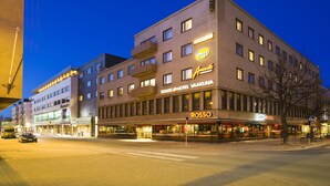 A multi-story hotel with a prominent 'ROSSO' sign on the ground floor, featuring a glass facade and multiple balconies. - Original Sokos Hotel Vaakuna Joensuu (Joensuu)