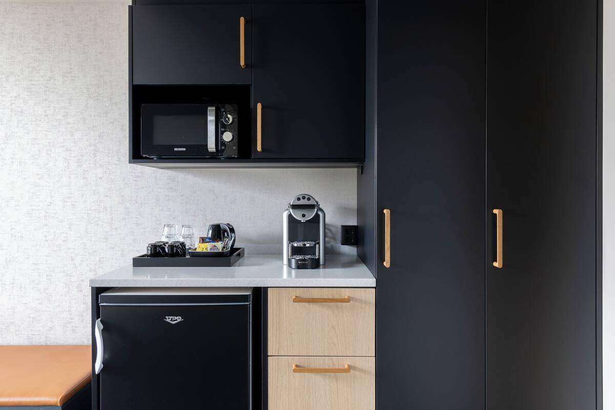 family room (standard) | in-room safe, desk, laptop workspace, iron/ironing board