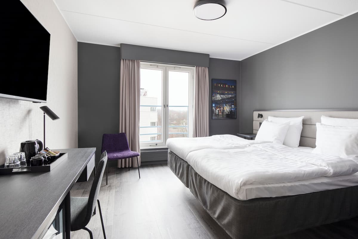 standard twin room | in-room safe, desk, laptop workspace, iron/ironing board