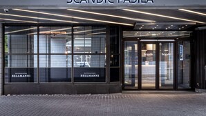 The exterior of Scandic Pasila hotel with large glass windows, a modern entrance, and the name 'Scandic Pasila' prominently displayed above the entrance. - Scandic Pasila (Helsinki)