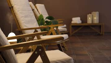 Relax in comfort with lounge chairs and a small table, surrounded by a serene ambiance.