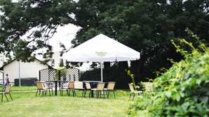 An outdoor seating area with a white canopy labeled "Park Hotel Economic." - Parkhotel Economic (Wielka Wies)