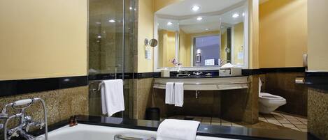 A modern bathroom with a bathtub, a sink, and a toilet.
