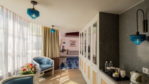 A modern hotel room with a seating area, a dining table, and a kitchenette. - Grand Swiss-Belhotel Melaka (Malacca City)