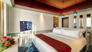 A hotel room with a large bed, a TV on the wall, and a desk with a chair. - Grand Swiss-Belhotel Melaka (Malacca City)