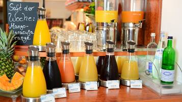 A juice bar with various fruit and vegetable juices, including mango, carrot, and pineapple.