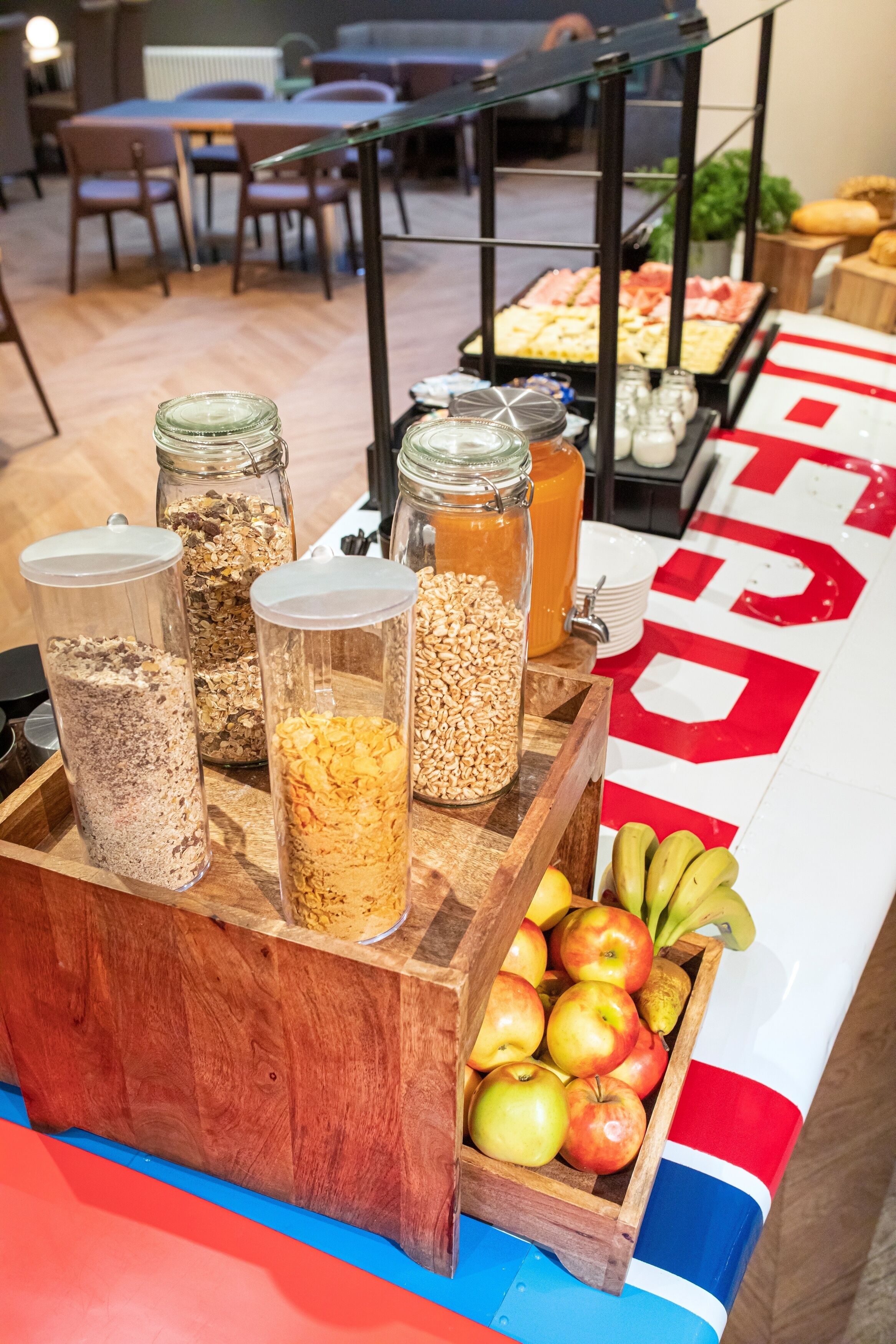 A breakfast buffet with various food items and a fruit display.