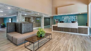 A spacious lobby with a reception desk, seating area, and a large plant. - Best Western Plus Vineyard Inn (Livermore)