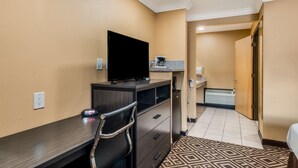 A hotel room with a desk, a flat-screen TV, a coffee maker, and a small kitchenette. - Americas Best Value Inn Ukiah (Ukiah)