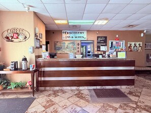A reception desk with a sign for 'Discovery Inn & Suites' and a 'No Smoking' sign. - Discovery Inn Lafayette Airport I-10 (Lafayette)
