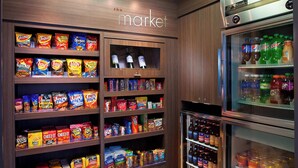 A snack and beverage display in a store with various chips and sodas.
