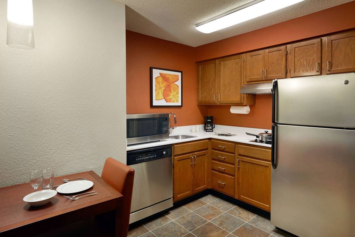 A compact kitchen with a microwave, coffee maker, and refrigerator.