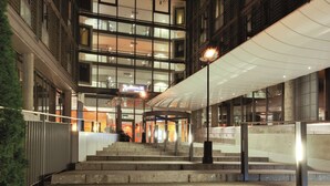 A multi-story hotel entrance with a glass facade, a covered outdoor area, and a staircase leading to the entrance. - Radisson Blu Airport Hotel, Oslo Gardermoen (Ullensaker)