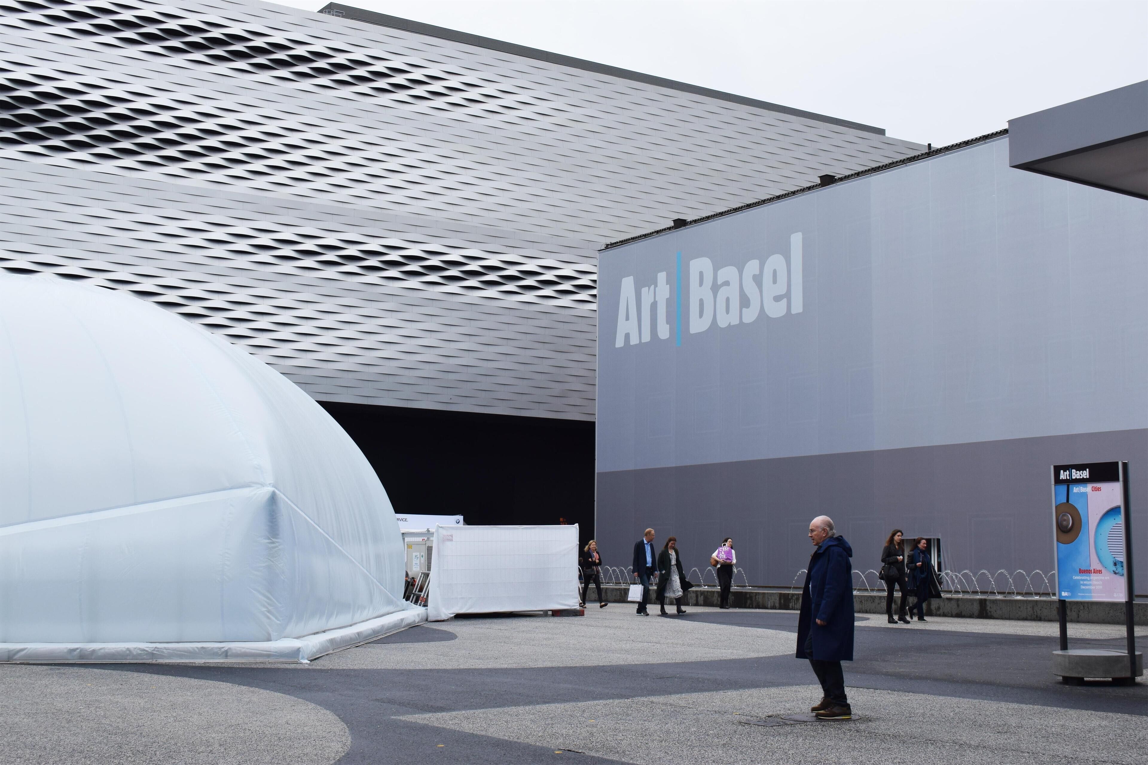 A modern building with a large sign reading "Art Basel."