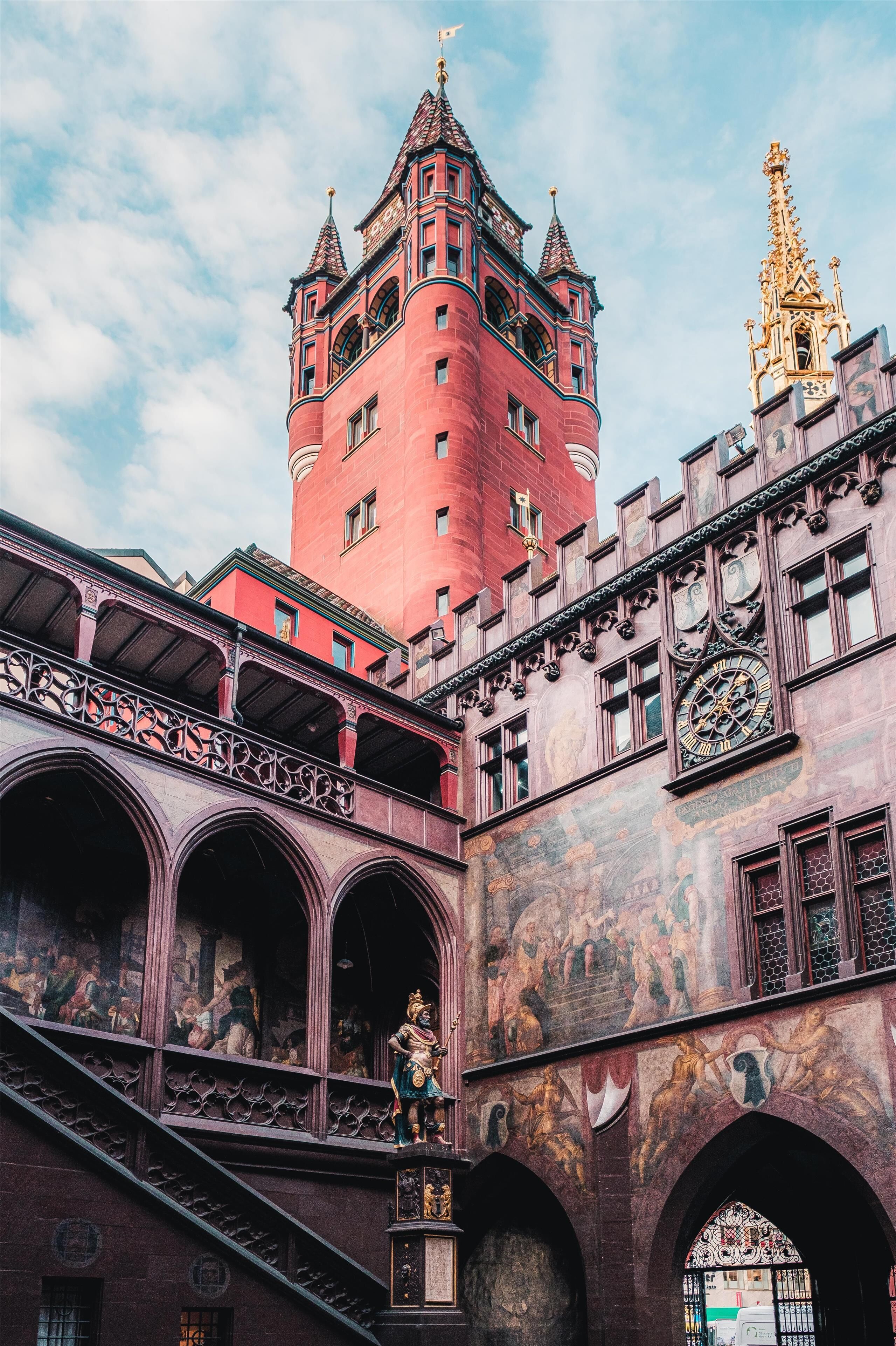 A historic building with a prominent tower and intricate architectural details.