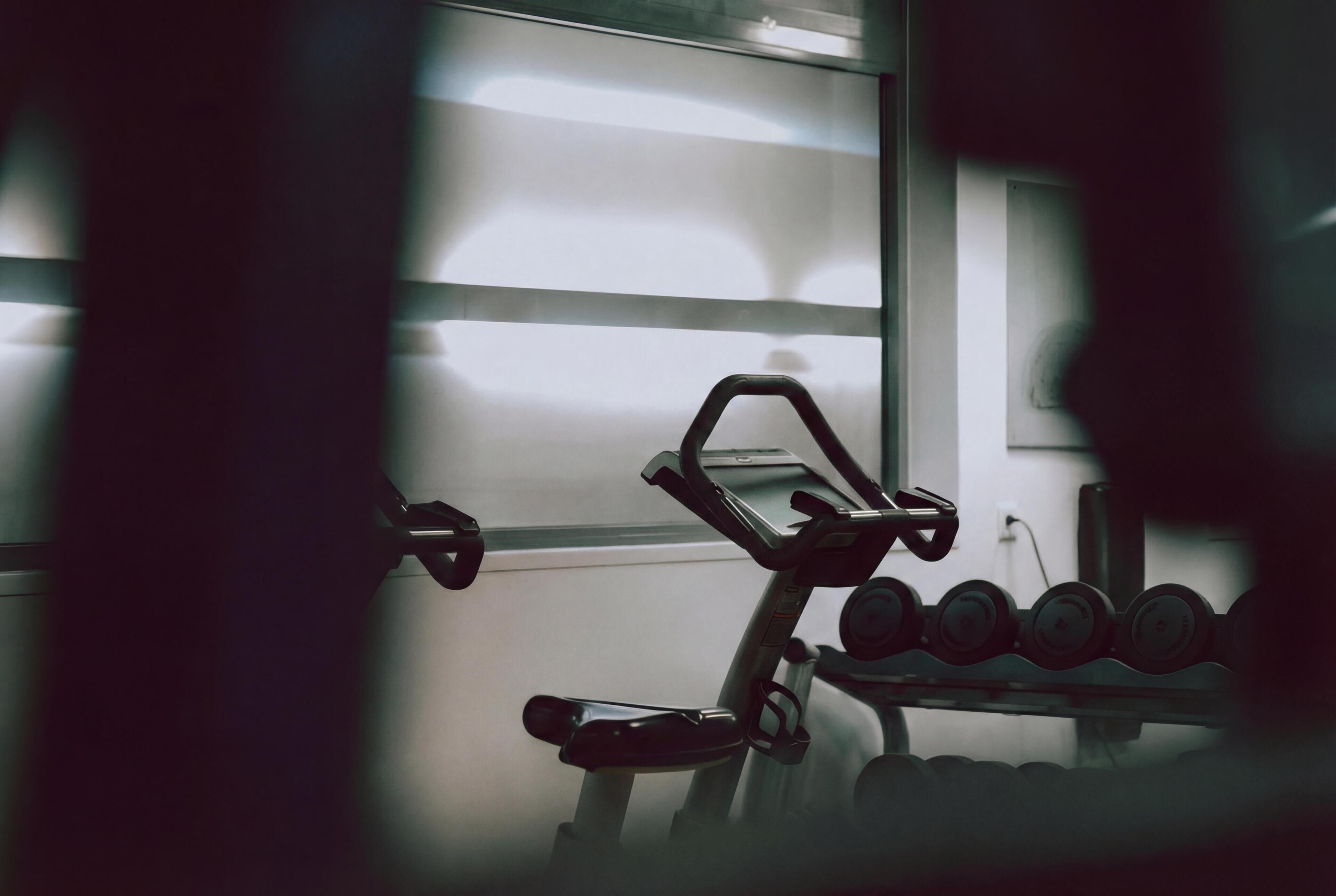 A gym with exercise equipment, including a stationary bike and dumbbells.