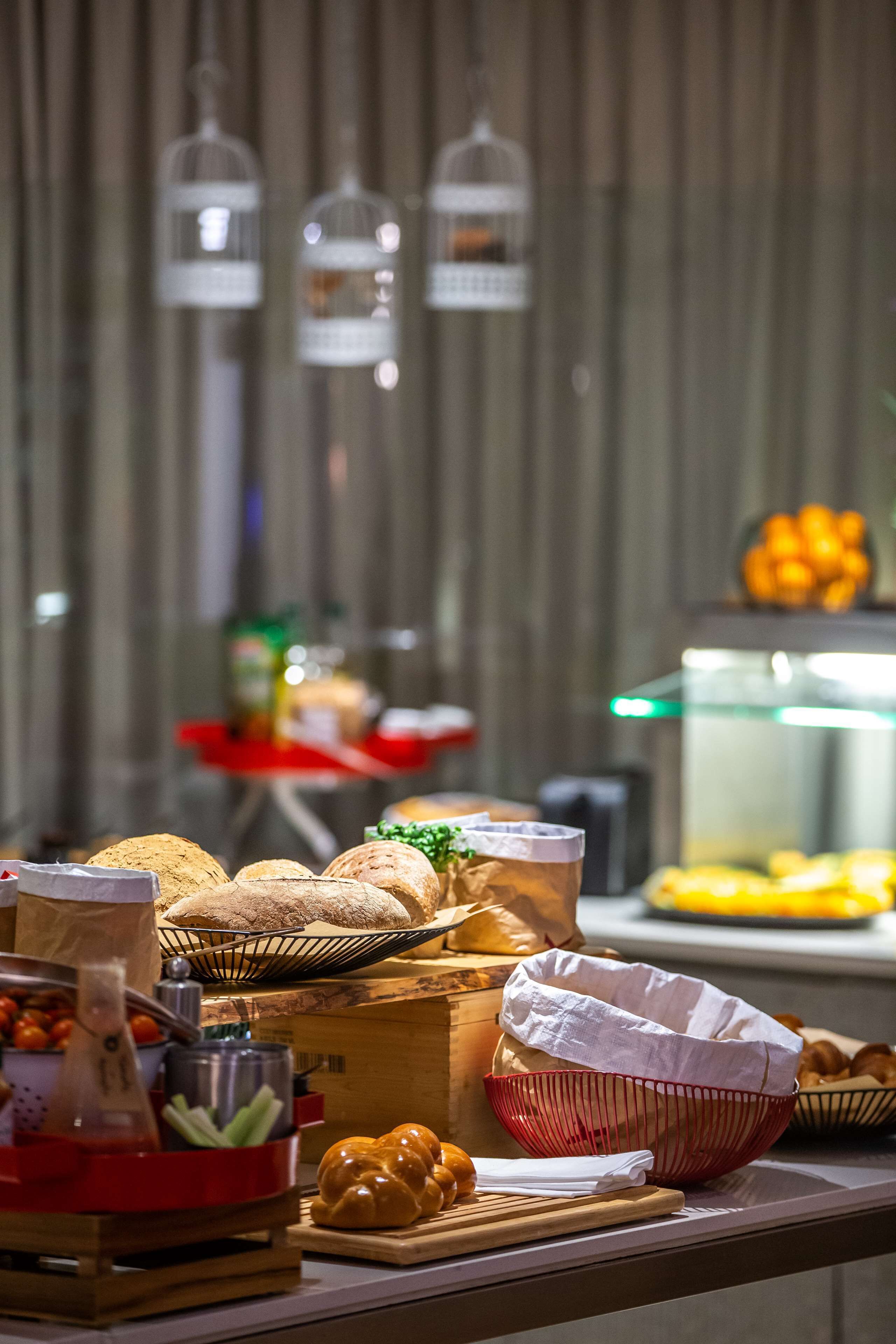 A buffet table with various food items and a salad bar.