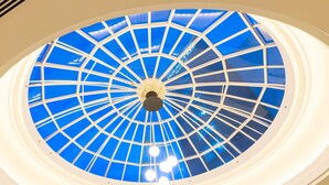 A large, circular skylight with a blue glass ceiling and white framing. - DoubleTree by Hilton Calgary North (Calgary)