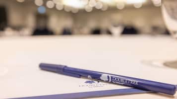 A pen on a table with a blurred background of a room.