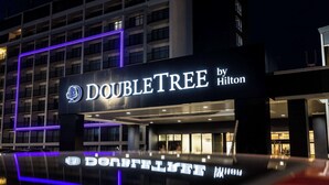 A hotel sign with the name "DOUBLETREE by Hilton" and a tree logo. - DoubleTree by Hilton Calgary North (Calgary)