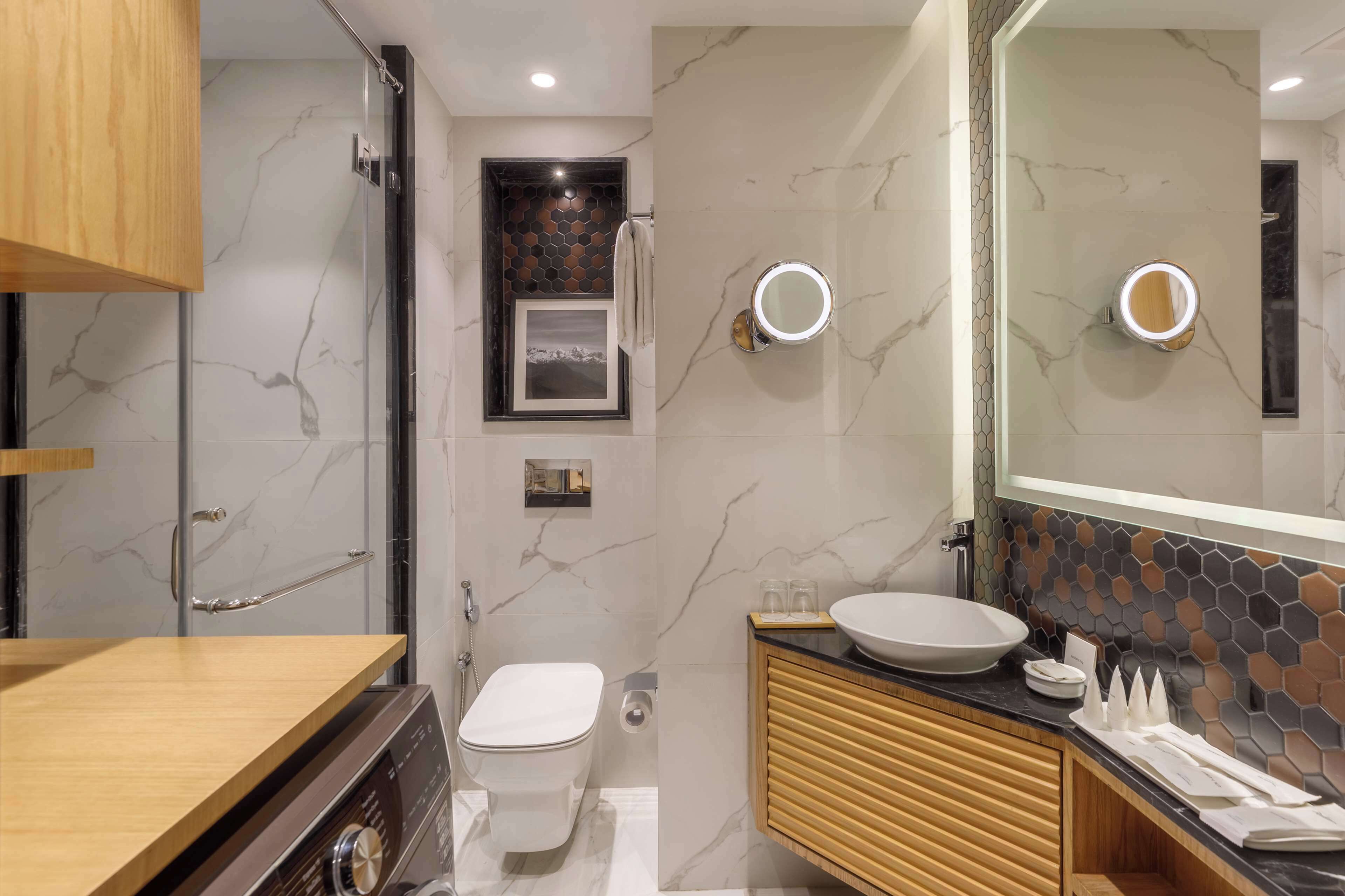A modern bathroom with a toilet, sink, and shower.