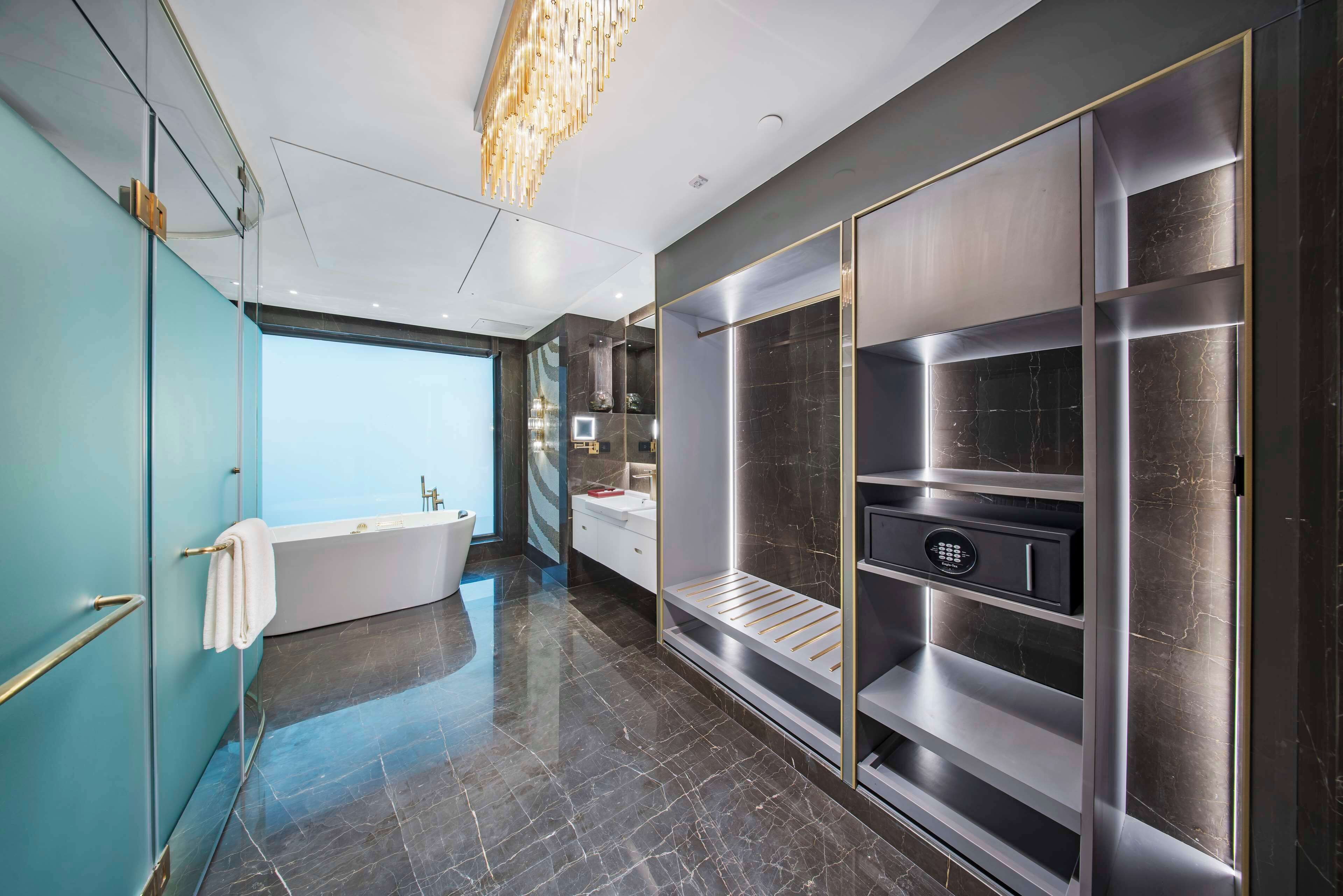 A modern bathroom with a bathtub, vanity, and built-in shelves.