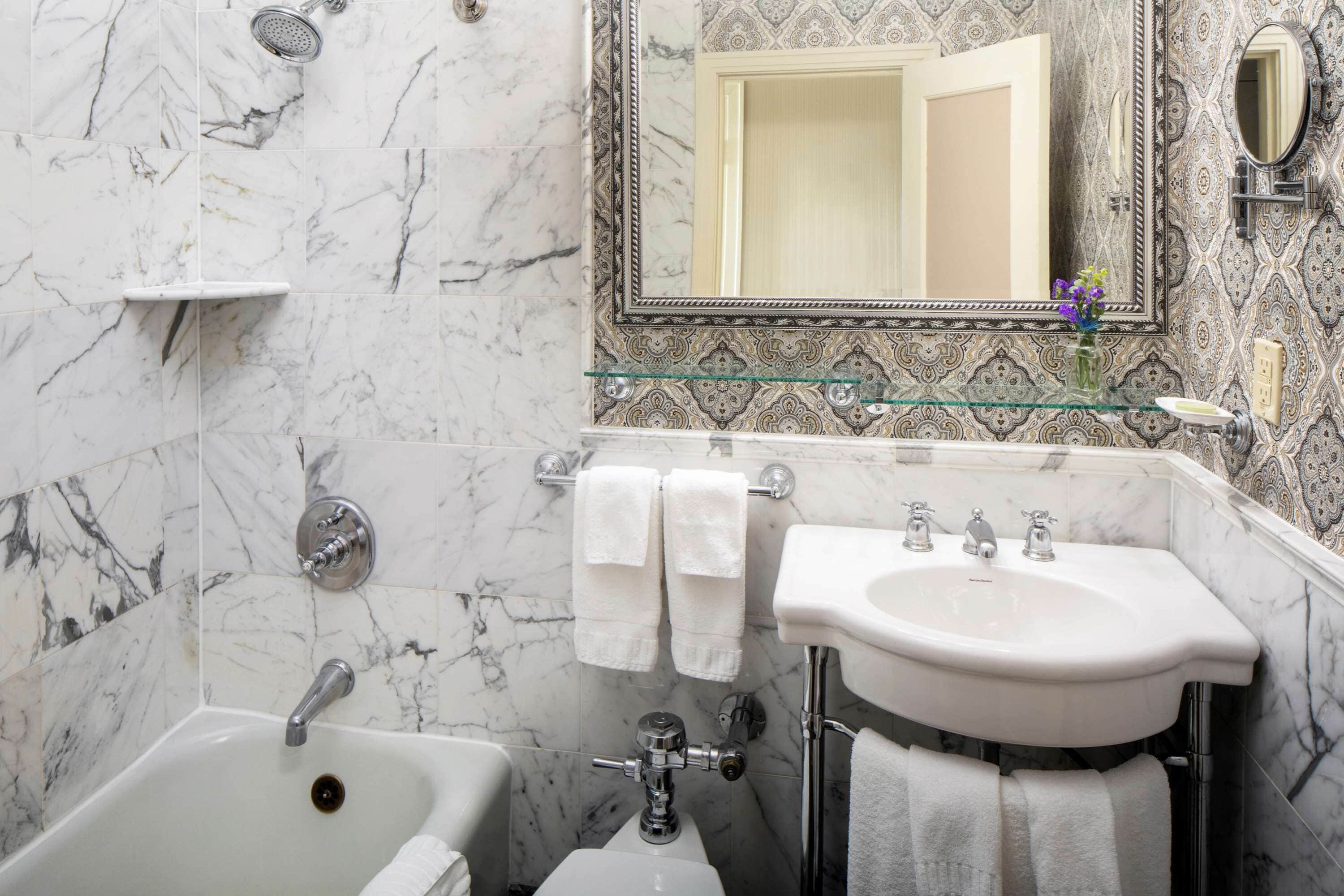 combined shower/bathtub, designer toiletries, hair dryer, bathrobes