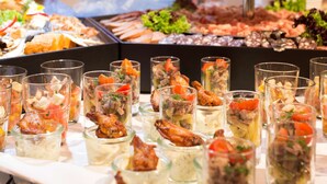 A buffet with various food items and drinks.