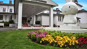 A building with a sign reading "Scandic Lillehammer" and a large white rabbit statue in front. - Scandic Lillehammer Hotel (Lillehammer)