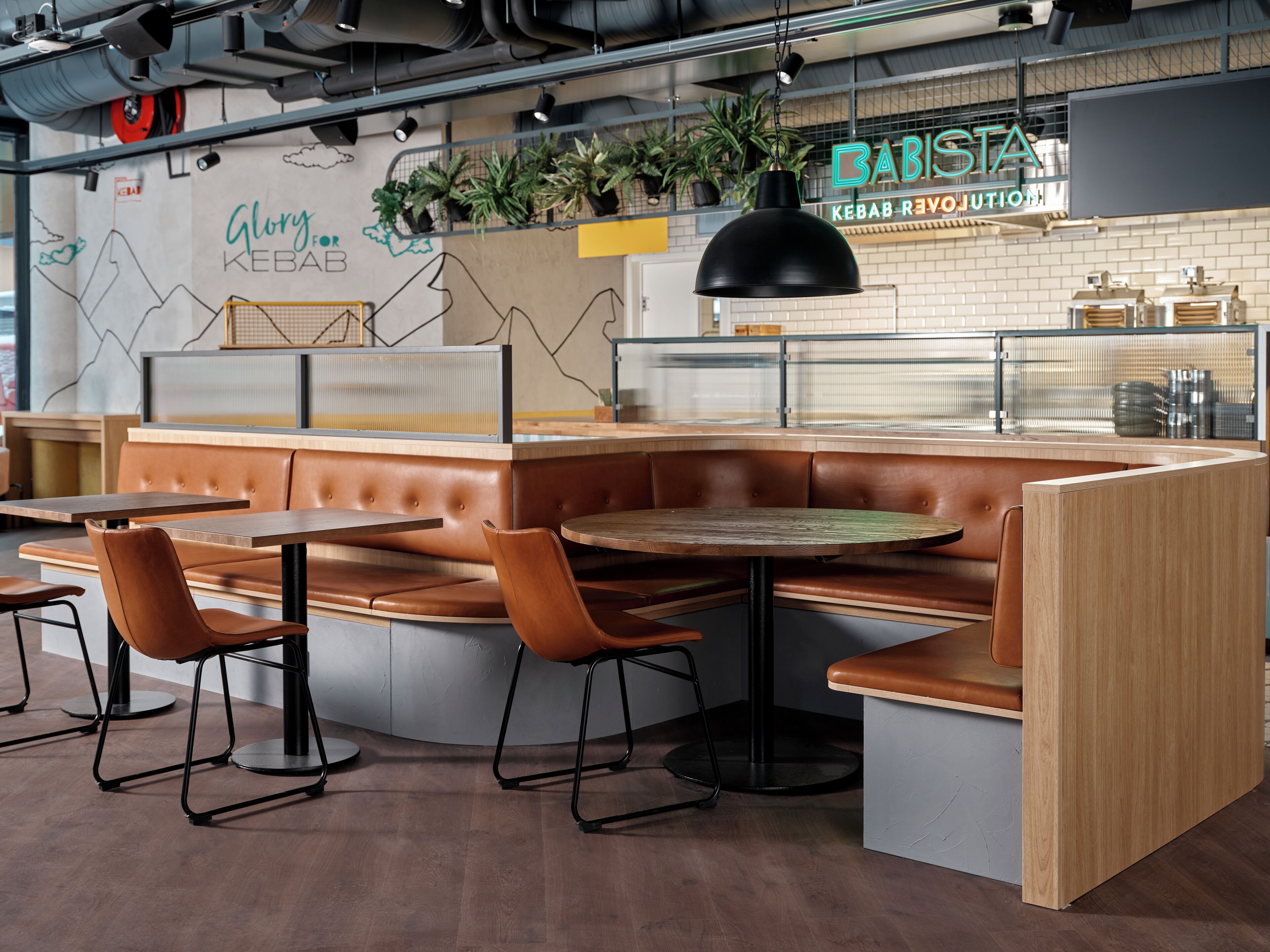 A restaurant interior with booth seating, tables, and a counter.