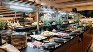 Un bufé con diversos alimentos y utensilios.