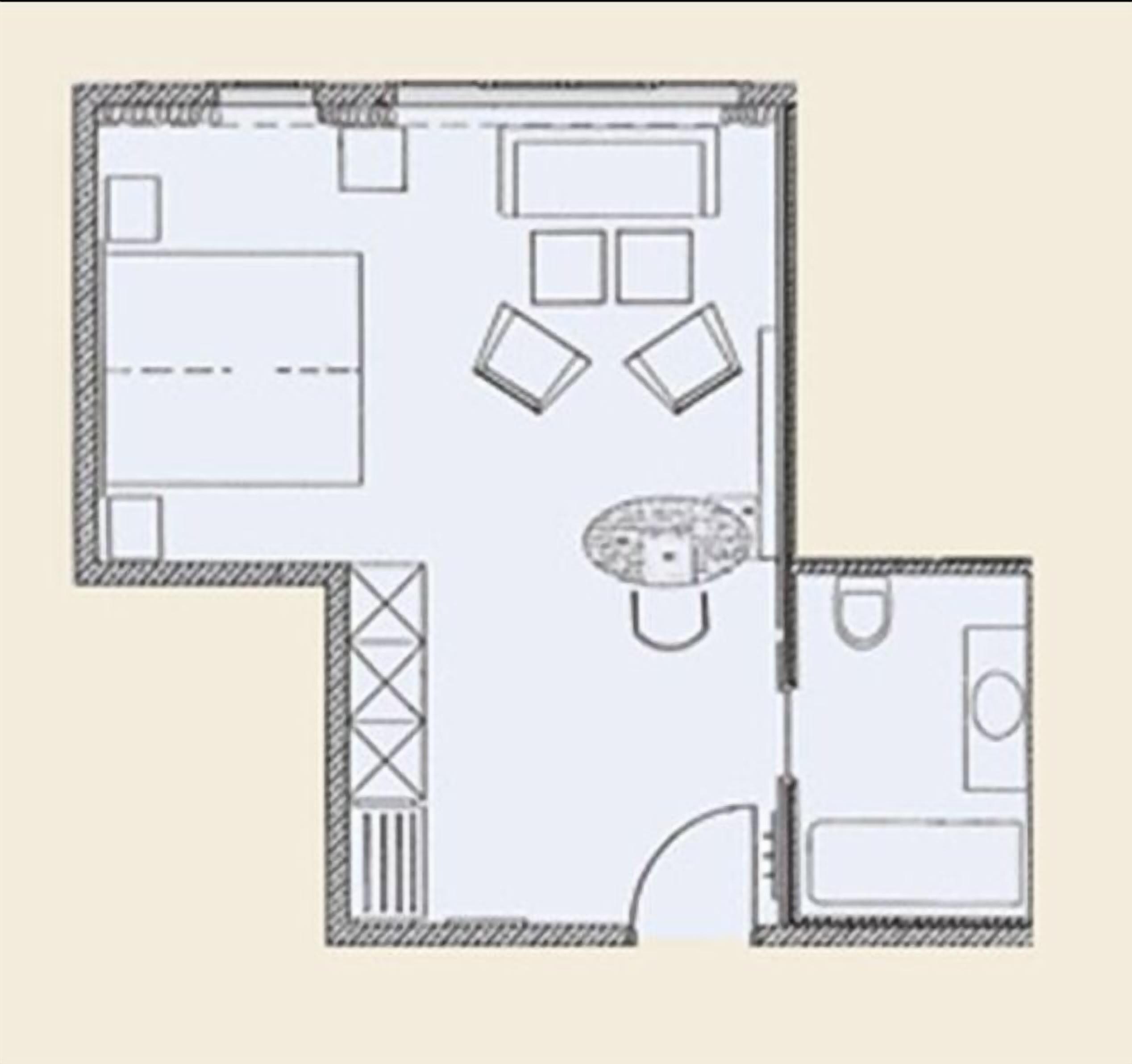 Plano de planta que muestra una cocina, comedor y una pequeña zona de estar.
