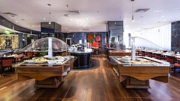A buffet setup with multiple serving stations, a central island, and a modern interior design.