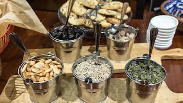 A table with metal containers holding various nuts and seeds.