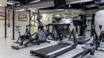 A gym with treadmills, stationary bikes, and weight machines.